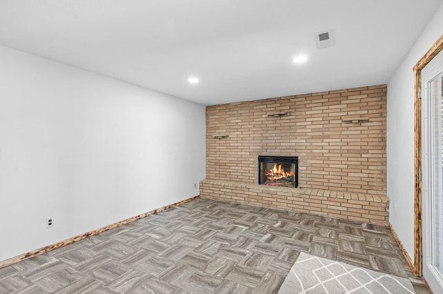 unfurnished living room with visible vents, a fireplace, baseboards, and recessed lighting