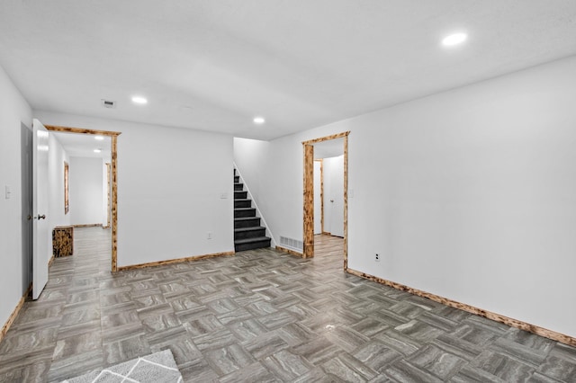 basement with baseboards, stairway, visible vents, and recessed lighting