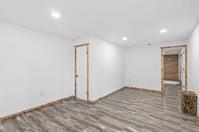 unfurnished room featuring recessed lighting and baseboards