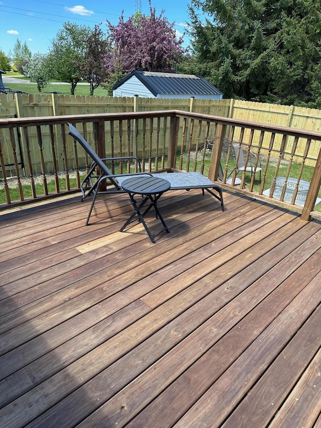 wooden deck featuring a fenced backyard