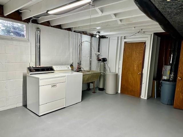 laundry room featuring laundry area, washing machine and dryer, and a sink