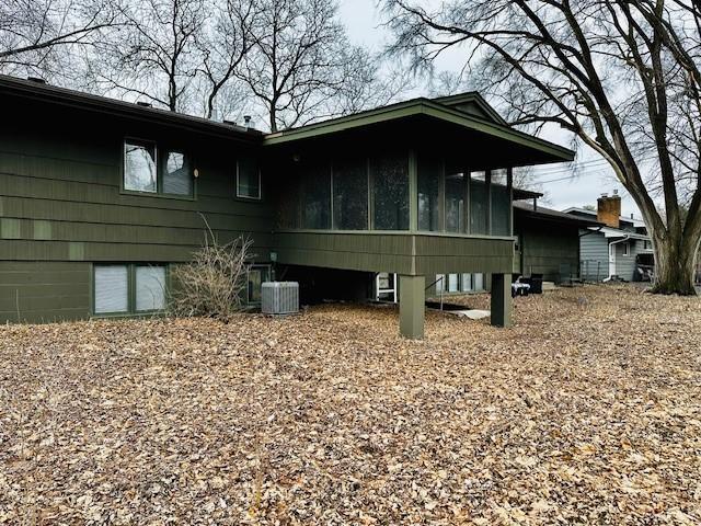 exterior space featuring a sunroom and central air condition unit