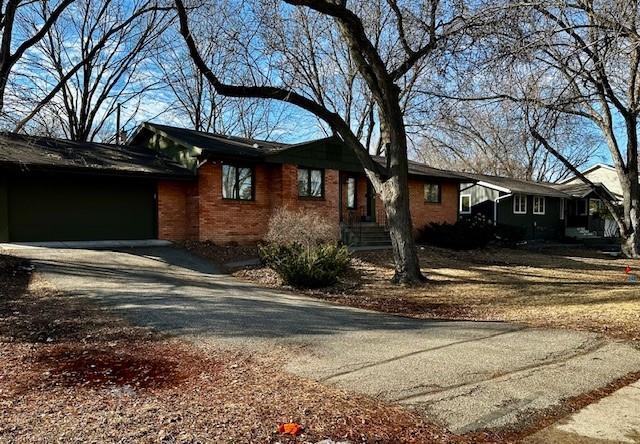 view of home's exterior with driveway and brick siding