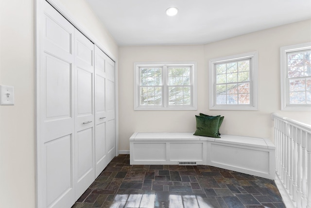 mudroom featuring stone finish floor