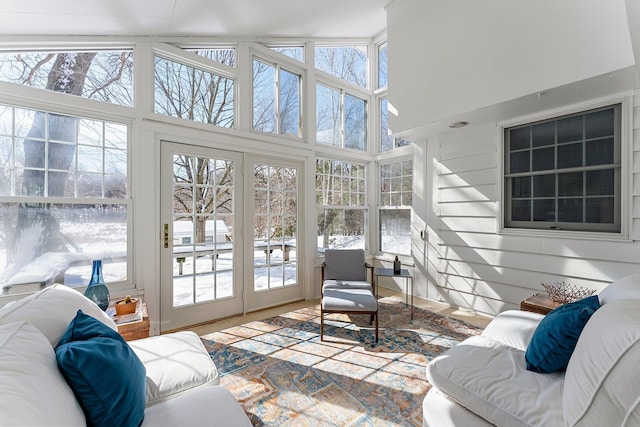 sunroom with lofted ceiling and a healthy amount of sunlight