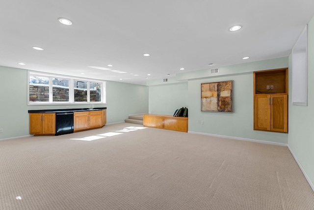 interior space with recessed lighting, light colored carpet, and baseboards