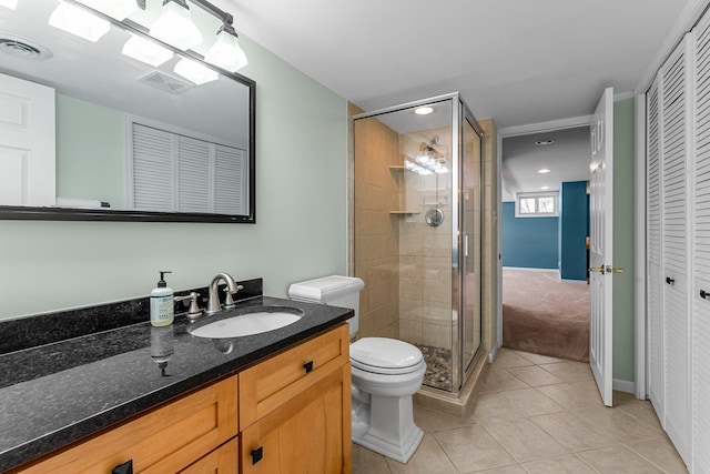 bathroom featuring visible vents, a shower stall, tile patterned floors, a closet, and vanity