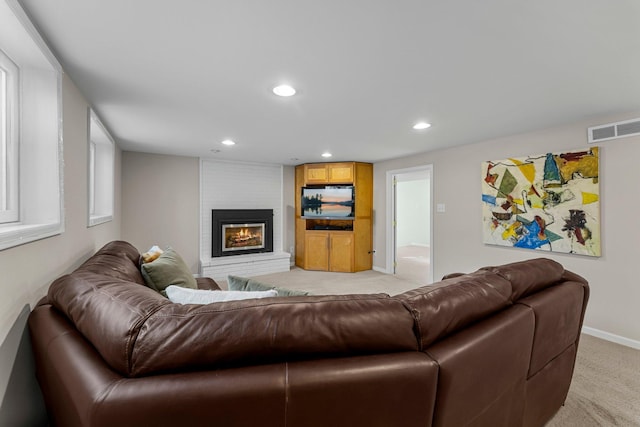 living room featuring visible vents, a brick fireplace, baseboards, light carpet, and recessed lighting