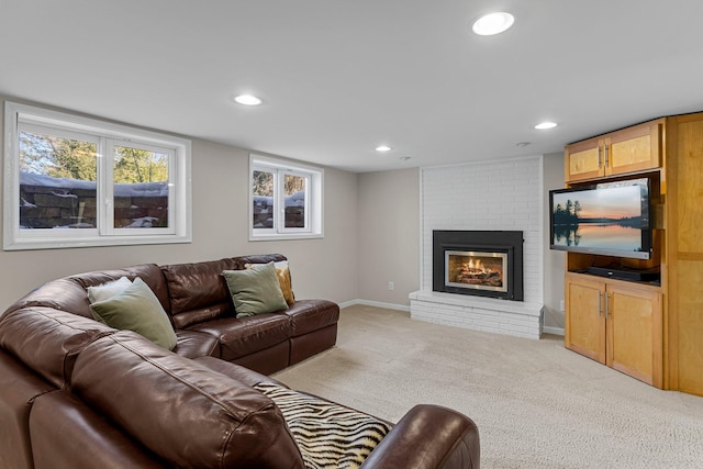 living area with recessed lighting, a brick fireplace, baseboards, and carpet