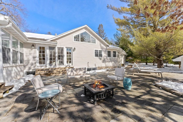 view of patio featuring french doors, an outdoor fire pit, and entry steps