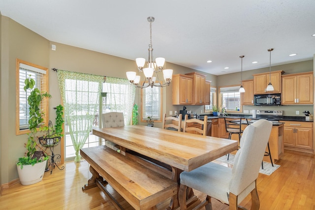 dining room featuring a notable chandelier, light wood-type flooring, baseboards, and recessed lighting