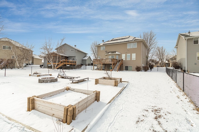 exterior space with stairs, a deck, fence, and a residential view