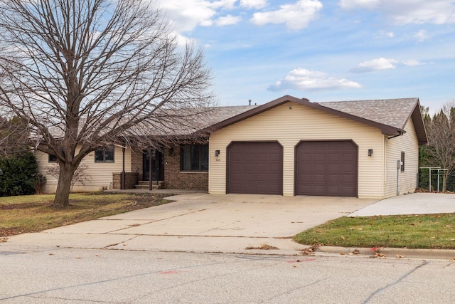 ranch-style house with concrete driveway, brick siding, and an attached garage