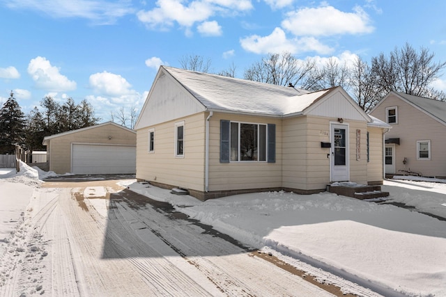 view of front of home with a garage and an outdoor structure