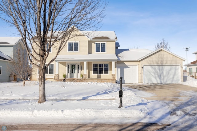 view of front facade featuring an attached garage, covered porch, and driveway