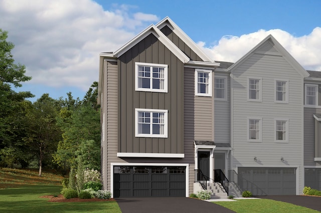 view of front facade featuring a garage, aphalt driveway, and board and batten siding