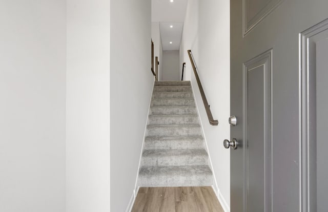 stairs with baseboards and wood finished floors