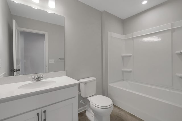 full bathroom with baseboards, toilet, shower / washtub combination, and vanity