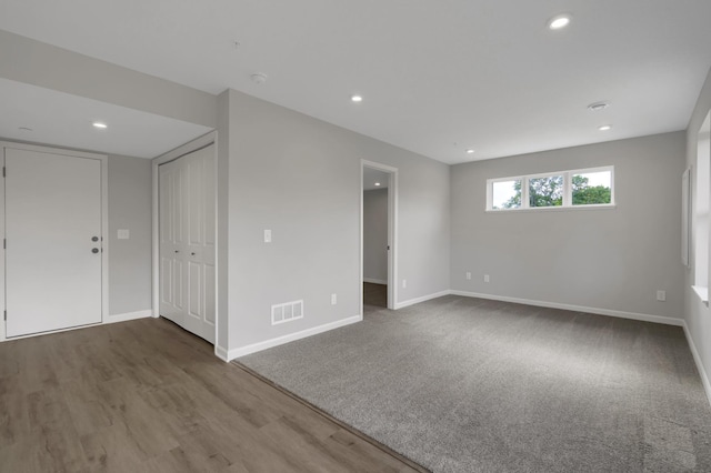 spare room featuring wood finished floors, recessed lighting, visible vents, and baseboards