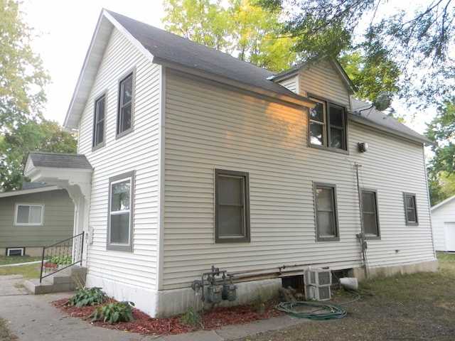 view of side of property with cooling unit