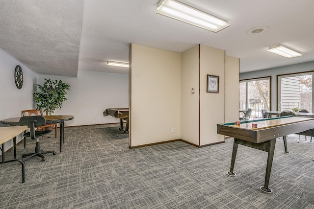 recreation room featuring a textured ceiling, baseboards, and carpet flooring