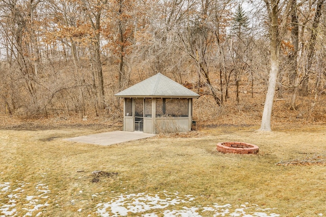 view of outbuilding with an outdoor fire pit