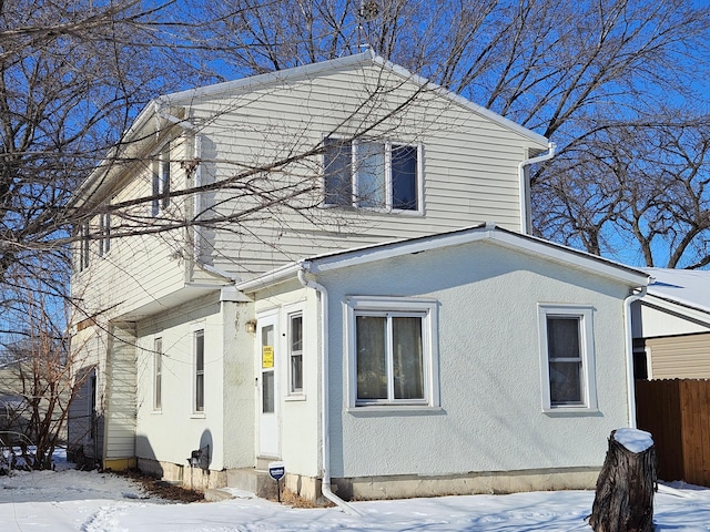 exterior space with fence and stucco siding