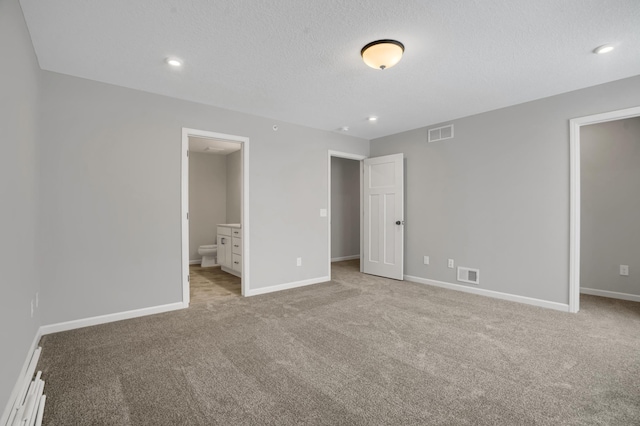 unfurnished bedroom featuring carpet floors, visible vents, and baseboards