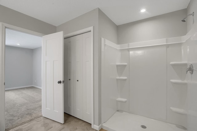 full bath featuring a stall shower and baseboards