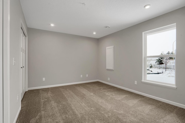 unfurnished bedroom featuring recessed lighting, carpet flooring, and baseboards