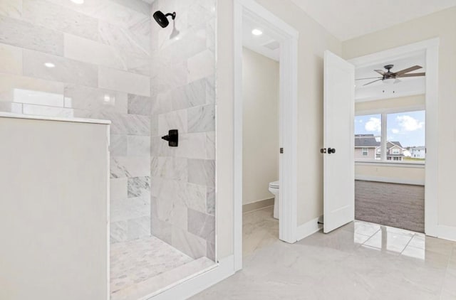 full bath featuring baseboards, toilet, a tile shower, marble finish floor, and a ceiling fan