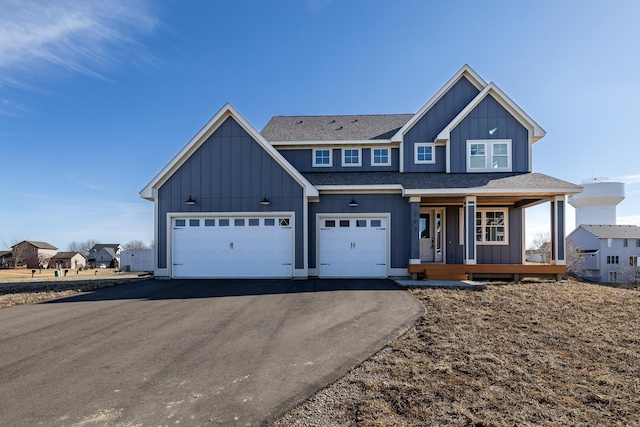 view of front of property featuring board and batten siding, covered porch, and driveway