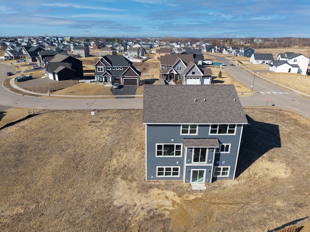 birds eye view of property with a residential view