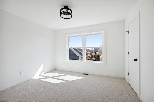 interior space with visible vents, baseboards, and carpet floors