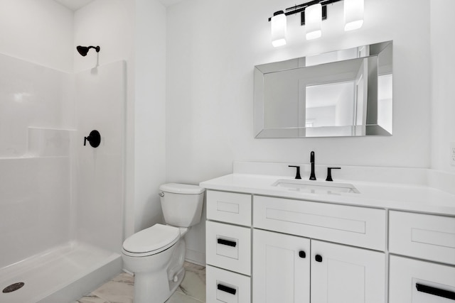 bathroom with toilet, marble finish floor, a stall shower, and vanity