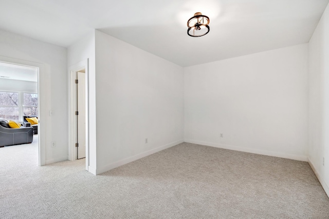 carpeted spare room with baseboards