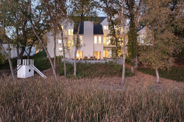 back of house with stucco siding