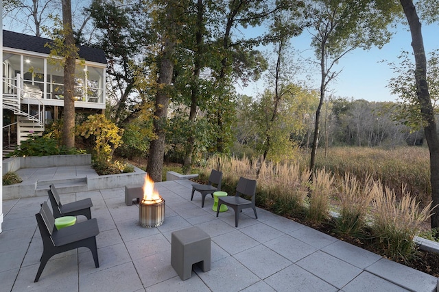 view of patio / terrace with stairway and a fire pit