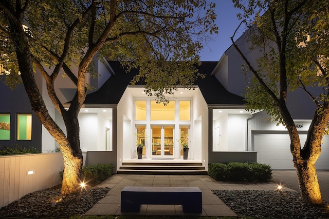 entrance to property featuring french doors and stucco siding