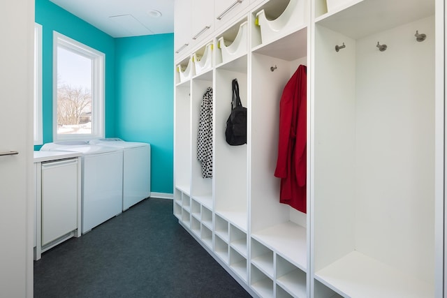 mudroom with washer and dryer and baseboards