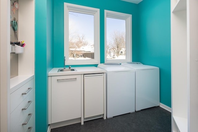 laundry room with a sink, cabinet space, and washing machine and dryer