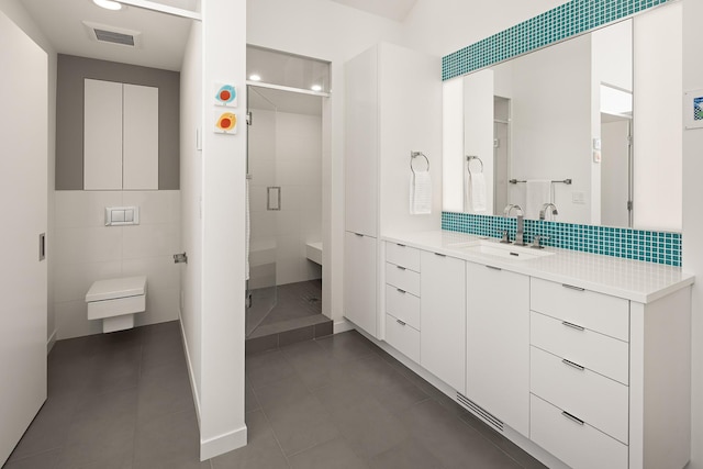 full bath featuring tile patterned flooring, visible vents, tasteful backsplash, a stall shower, and vanity