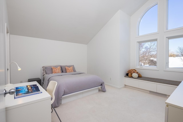 bedroom with visible vents, light carpet, baseboards, and vaulted ceiling