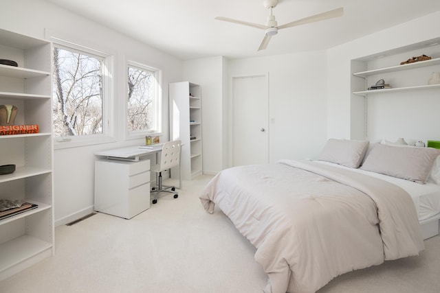 bedroom with light carpet, ceiling fan, and baseboards