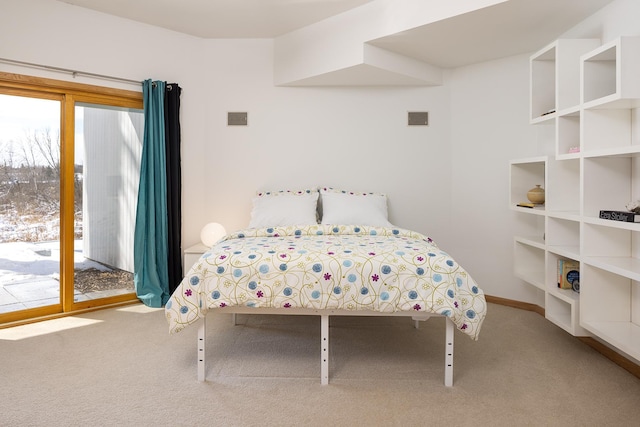 bedroom with visible vents, carpet floors, and access to outside