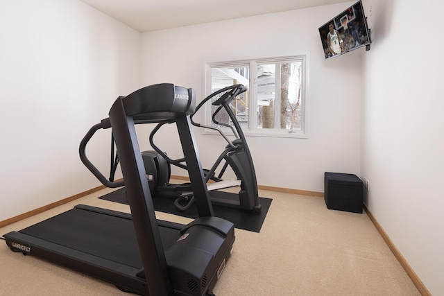 exercise room featuring baseboards and carpet floors