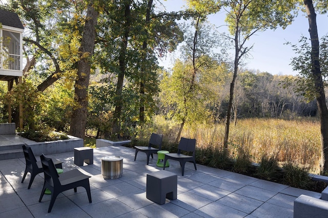 view of patio / terrace featuring a wooded view