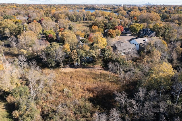 birds eye view of property featuring a wooded view