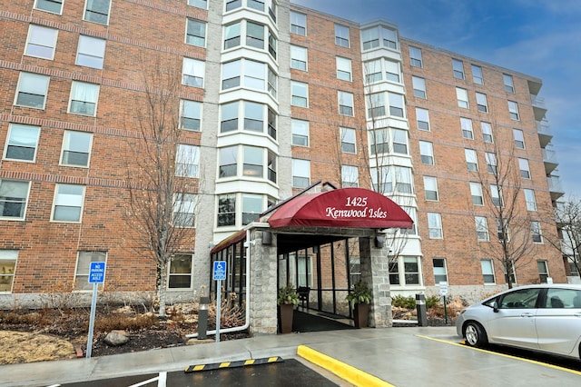 view of building exterior featuring uncovered parking