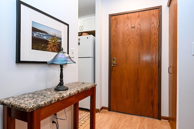 entryway featuring light wood-type flooring and baseboards